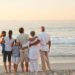 A multi-generational family standing on a beach facing the ocean; how to write a book about your life